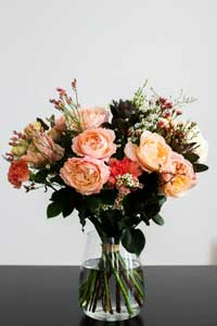 orange/coral/pink flower bouquet in a vase